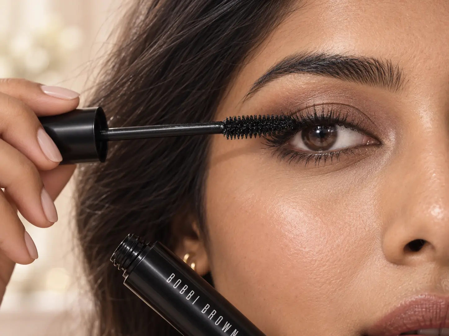 Applying Bobbi Brown mascara from lash roots to tips
