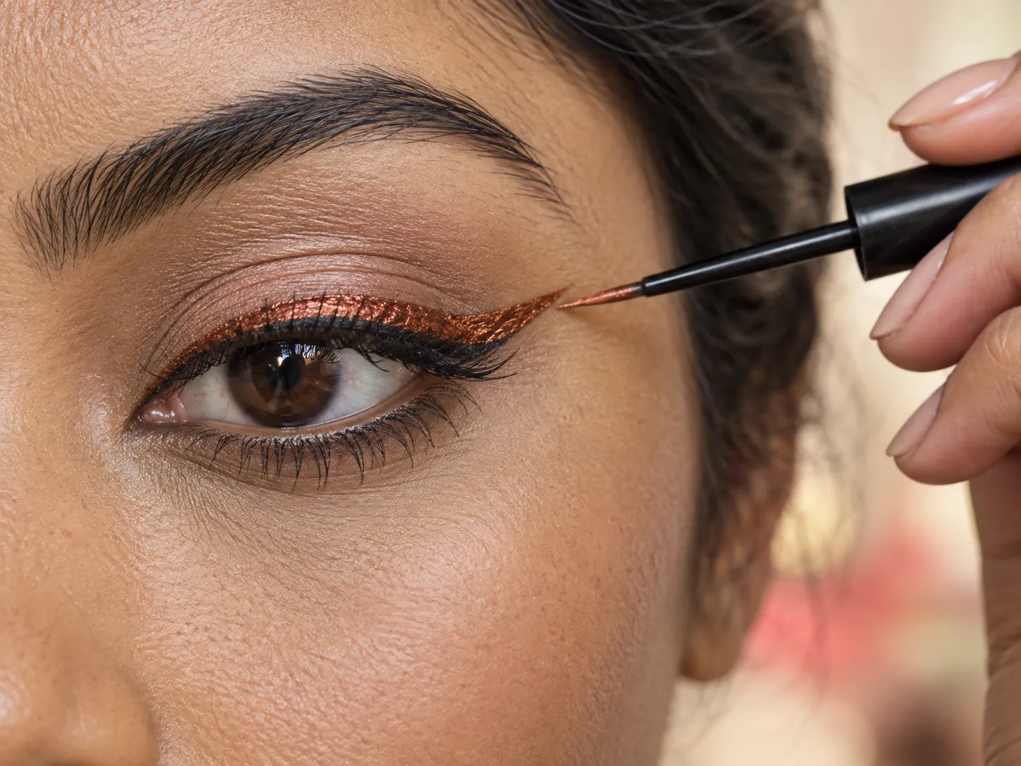 Step-by-step application of copper liquid eyeliner